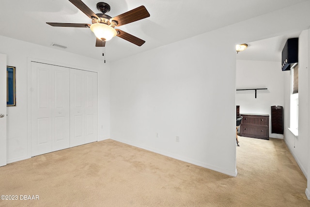 665 Elk River Dr, Ormond Beach, FL 32174 - unfurnished bedroom with a closet, light colored carpet, and ceiling fan