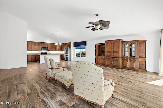 665 Elk River Dr, Ormond Beach, FL 32174 - living room featuring hardwood / wood-style flooring, ceiling fan with notable chandelier, sink, and vaulted ceiling