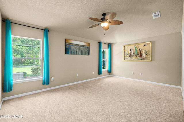 665 Elk River Dr, Ormond Beach, FL 32174 - carpeted empty room featuring a textured ceiling and ceiling fan
