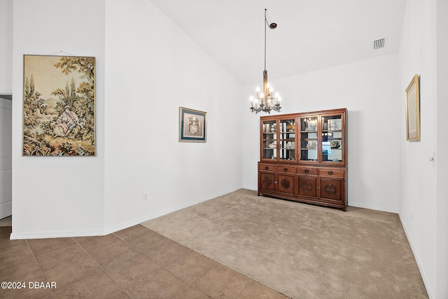 665 Elk River Dr, Ormond Beach, FL 32174 - unfurnished dining area with high vaulted ceiling, carpet floors, and a notable chandelier