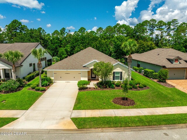 665 Elk River Dr, Ormond Beach, FL 32174 - view of front of property with a garage and a front yard