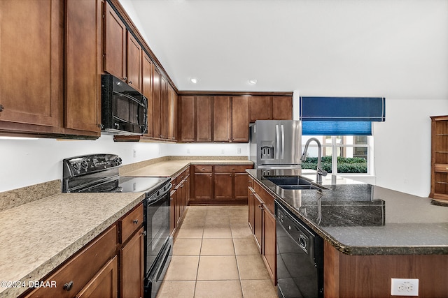 665 Elk River Dr, Ormond Beach, FL 32174 - kitchen with light tile patterned floors, a kitchen island with sink, sink, and black appliances
