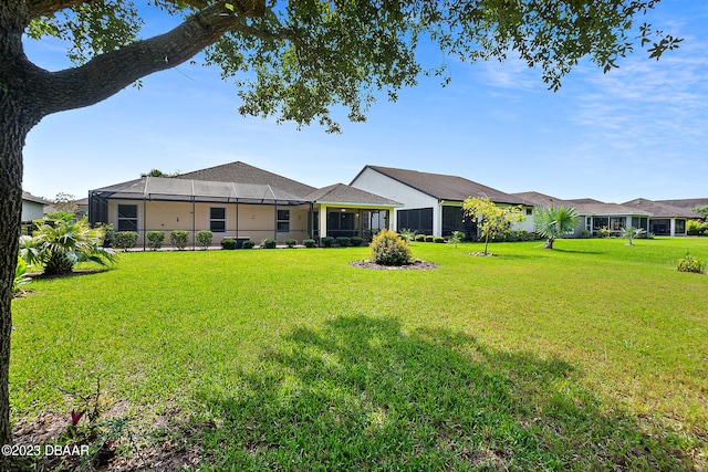 665 Elk River Dr, Ormond Beach, FL 32174 - view of front of house featuring glass enclosure, a front yard, and a sunroom