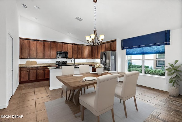 665 Elk River Dr, Ormond Beach, FL 32174 - kitchen featuring black appliances, a chandelier, an island with sink, high vaulted ceiling, and pendant lighting