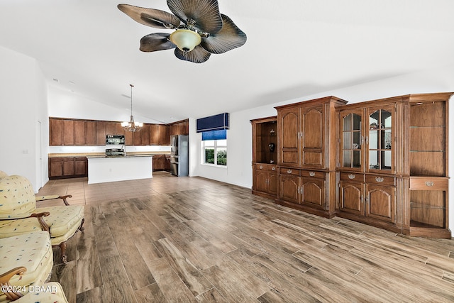 665 Elk River Dr, Ormond Beach, FL 32174 - unfurnished living room with hardwood / wood-style floors, vaulted ceiling, and ceiling fan with notable chandelier
