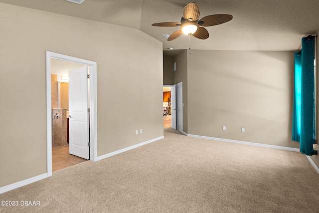 665 Elk River Dr, Ormond Beach, FL 32174 - unfurnished bedroom featuring vaulted ceiling, light carpet, ceiling fan, and a textured ceiling