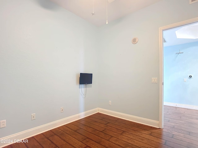 unfurnished room with dark hardwood / wood-style floors