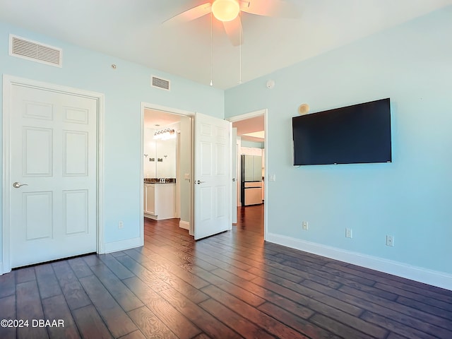 unfurnished bedroom with dark hardwood / wood-style flooring, ensuite bathroom, and ceiling fan