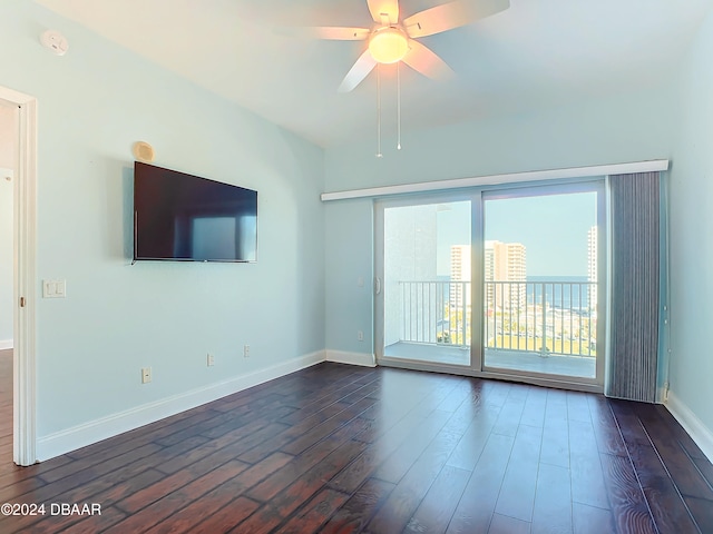 unfurnished living room featuring dark hardwood / wood-style flooring and ceiling fan