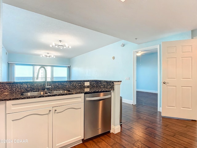 kitchen with white cabinetry, sink, dark wood-type flooring, stainless steel dishwasher, and dark stone countertops