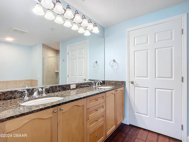 bathroom with a shower with door, vanity, and hardwood / wood-style flooring