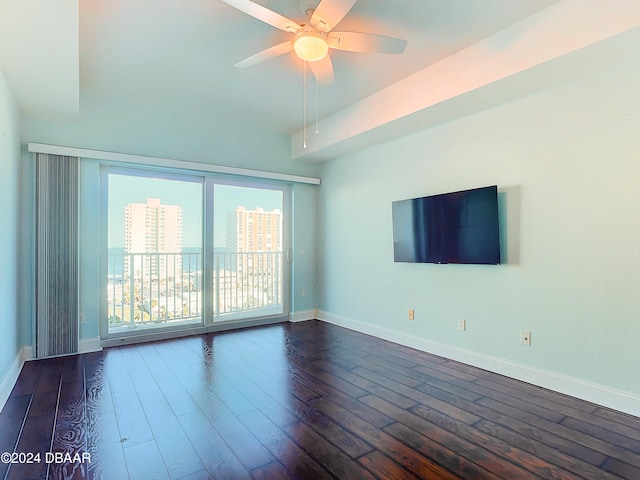 spare room with dark hardwood / wood-style floors and ceiling fan