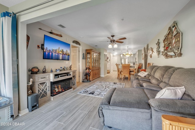 living room with light wood-type flooring and ceiling fan