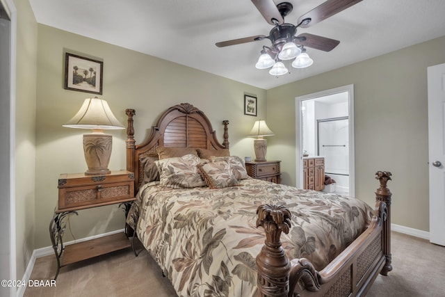 carpeted bedroom with ceiling fan and connected bathroom