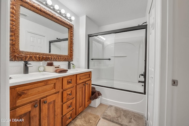 bathroom featuring vanity, tile patterned flooring, a textured ceiling, and shower / bath combination with glass door