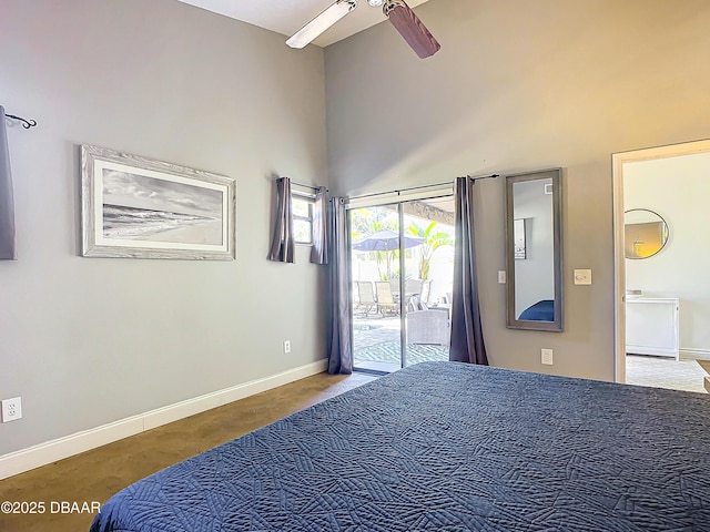 bedroom with ceiling fan, access to exterior, and a high ceiling