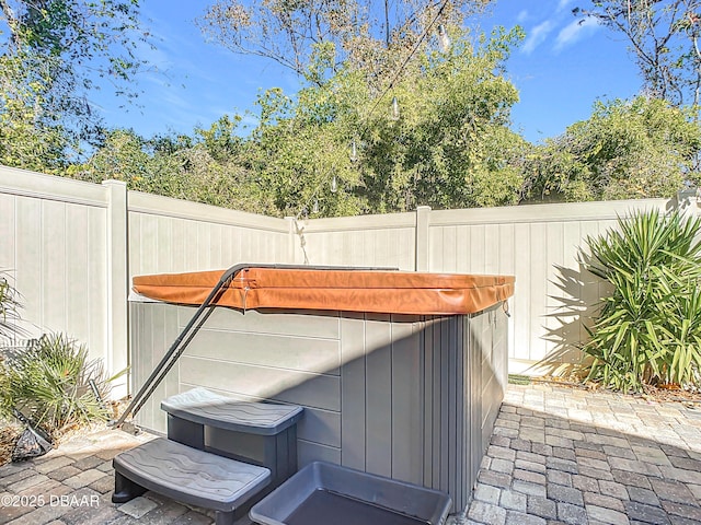 view of patio / terrace featuring a hot tub