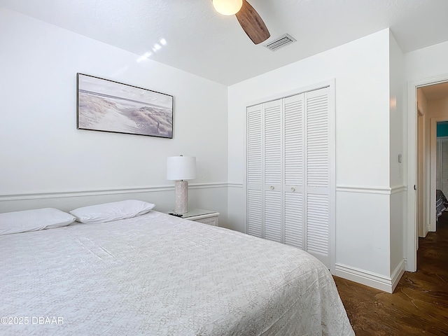 bedroom featuring dark hardwood / wood-style floors, a closet, and ceiling fan