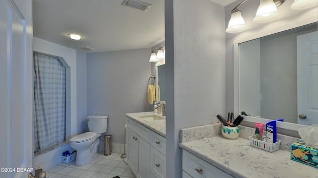 bathroom featuring toilet, vanity, tile patterned floors, and curtained shower