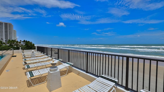 exterior space featuring a beach view and a water view