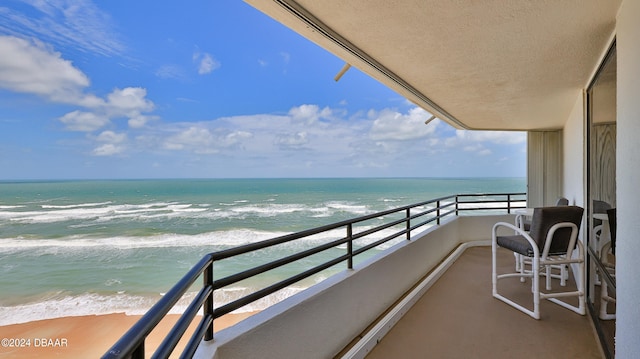 balcony with a beach view and a water view