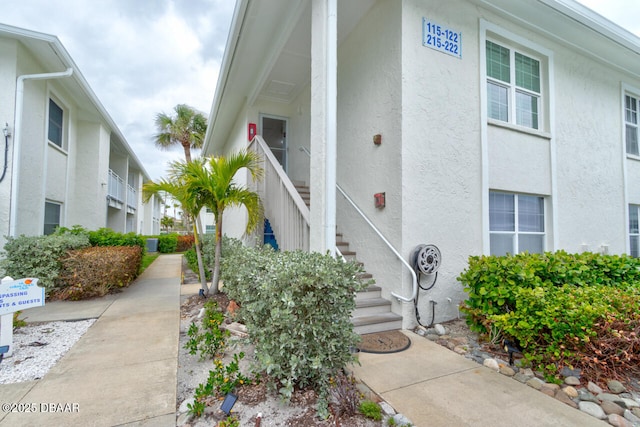 view of exterior entry featuring stucco siding