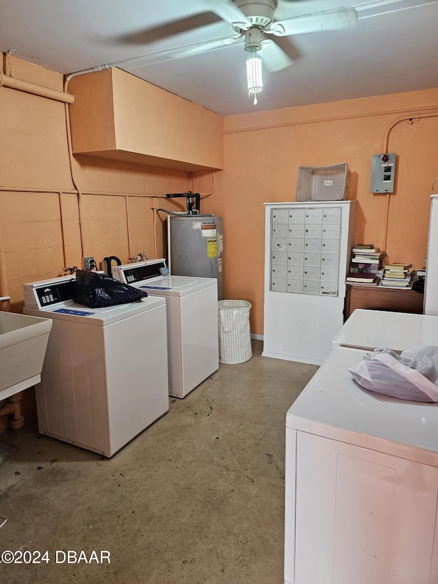 clothes washing area featuring sink, separate washer and dryer, ceiling fan, and water heater