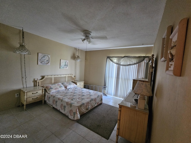 bedroom with ceiling fan and a textured ceiling