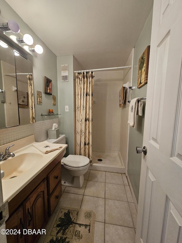 bathroom featuring curtained shower, tile patterned flooring, vanity, and toilet