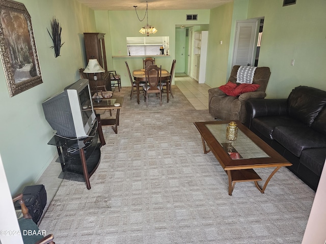 tiled living room featuring a notable chandelier