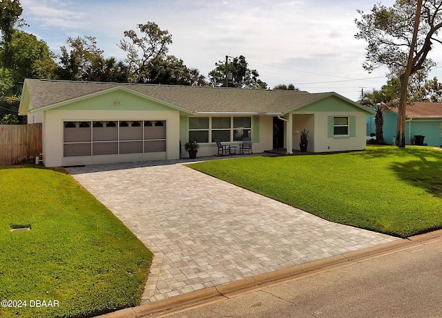 ranch-style home featuring a garage and a front lawn