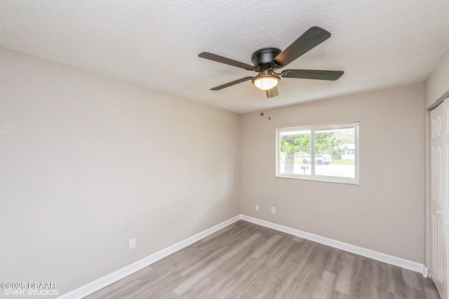 spare room featuring light hardwood / wood-style floors, a textured ceiling, and ceiling fan