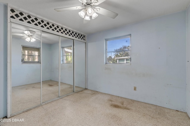 unfurnished bedroom with a closet and ceiling fan