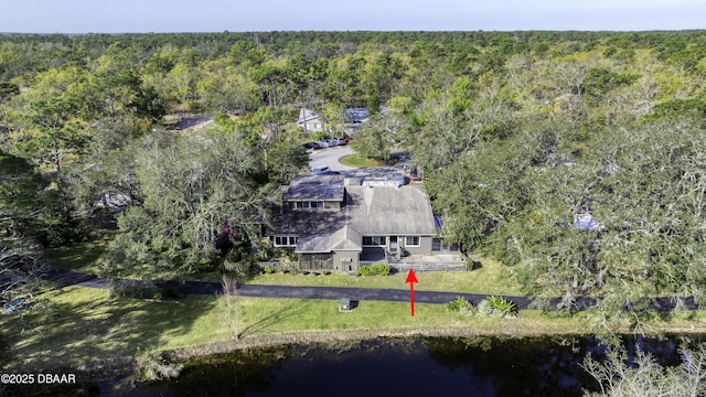 aerial view featuring a forest view and a water view