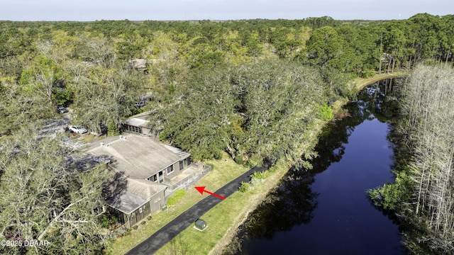 bird's eye view featuring a forest view and a water view