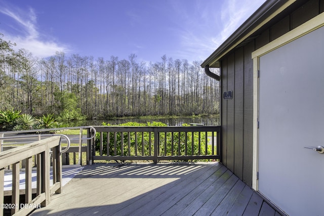 wooden terrace featuring a forest view