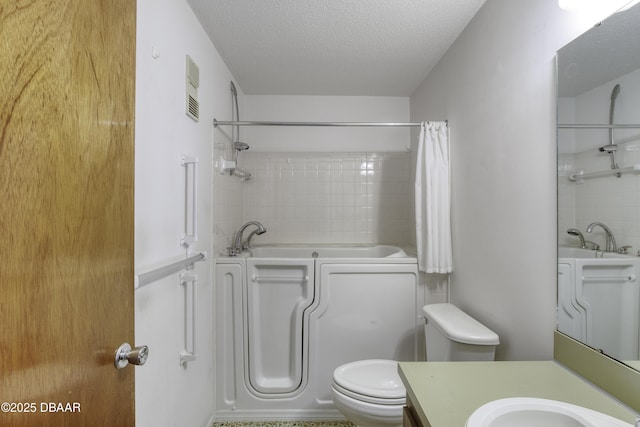 bathroom with vanity, toilet, visible vents, and a textured ceiling