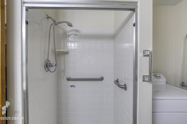 full bath with a shower stall and washer / clothes dryer