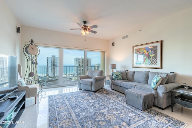 living room featuring light tile patterned floors and ceiling fan