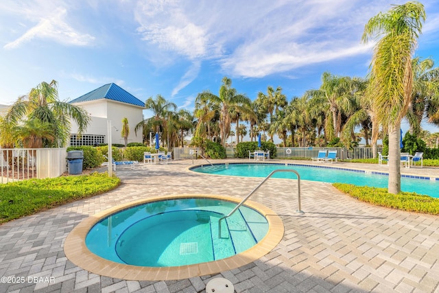 pool featuring a community hot tub, fence, and a patio