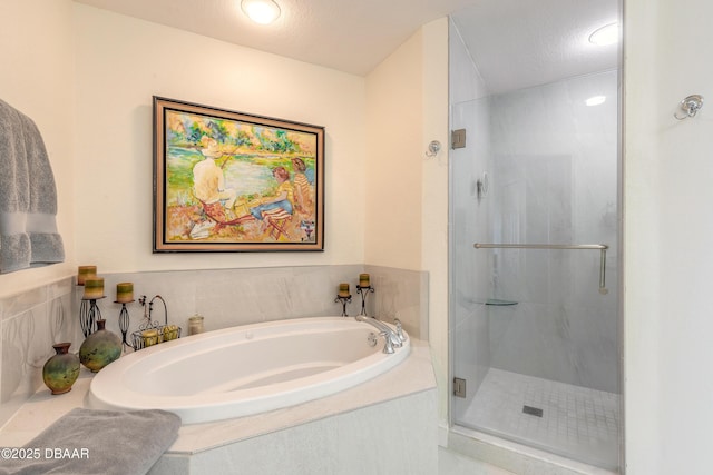 bathroom featuring a stall shower and a bath