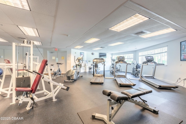 gym with a paneled ceiling and visible vents