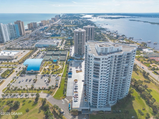 birds eye view of property with a city view and a water view