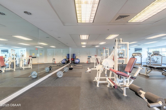 gym featuring visible vents and a paneled ceiling