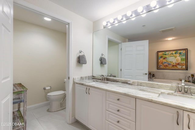 bathroom featuring double vanity, visible vents, toilet, and a sink