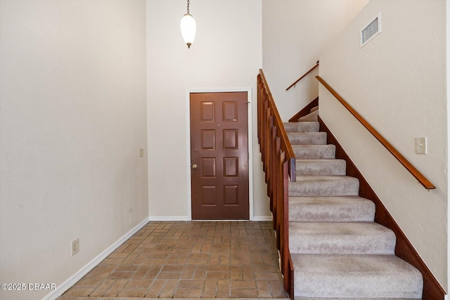 foyer entrance with a towering ceiling