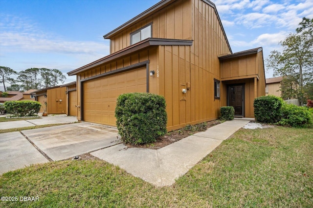 view of side of property featuring a garage and a yard