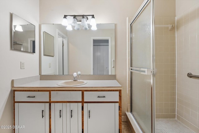 bathroom with vanity and a shower with door