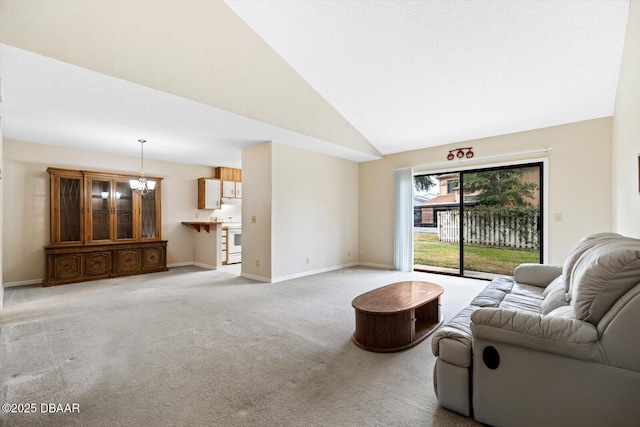 living room with an inviting chandelier, light carpet, and high vaulted ceiling