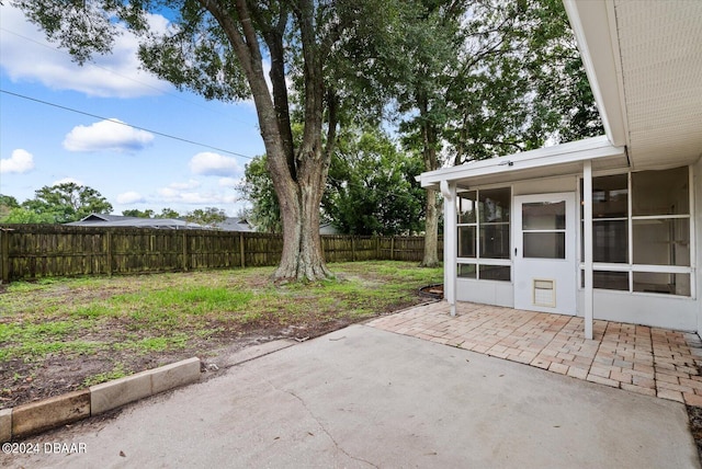 view of patio featuring a sunroom